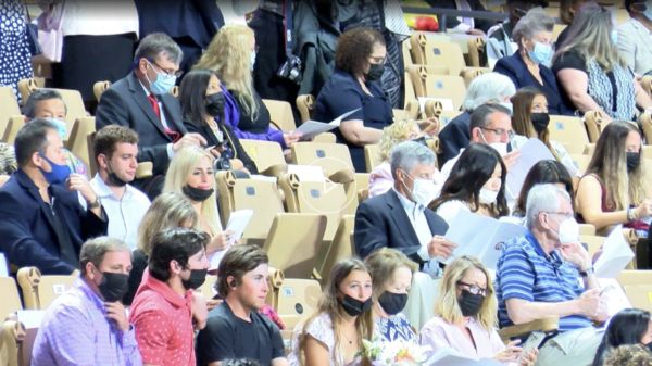 attendees look on as the ceremony commences