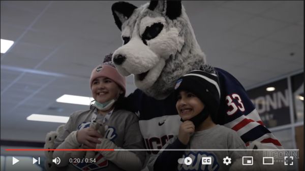 Gabby smiles with the UConn Husky