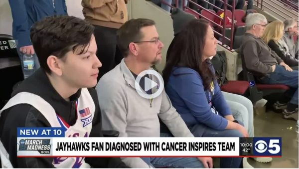 Jayhawks fan looks on with family to watch the basketball game