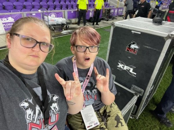 Kayden and company give the NIU hand sign to the camera