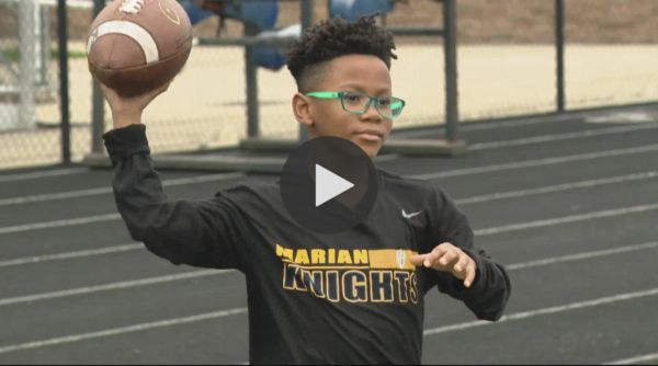 Trace Butlers holds the football high and proud as he wears Marian Knights attire